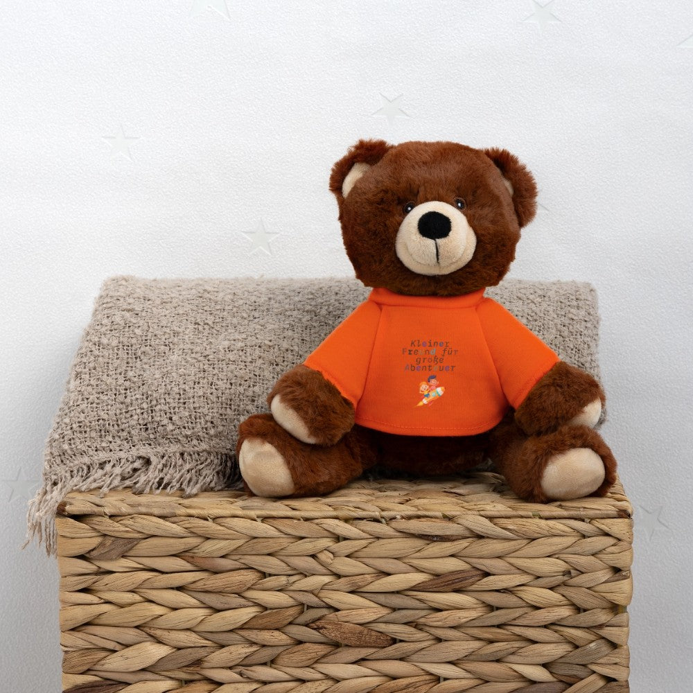 Teddy Bär als Kuscheltier in Seitenansicht im Kinderzimmer - Goldenes Orange